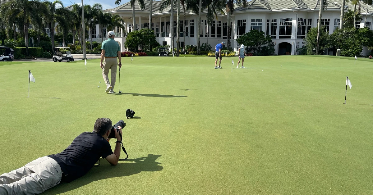 Photographer capturing golf practice on green