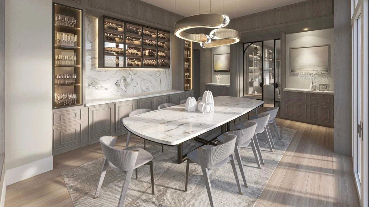Elegant luxury dining room featuring a marble table, bespoke cabinetry with wine storage, and a sculptural pendant light over wide-plank hardwood floors.